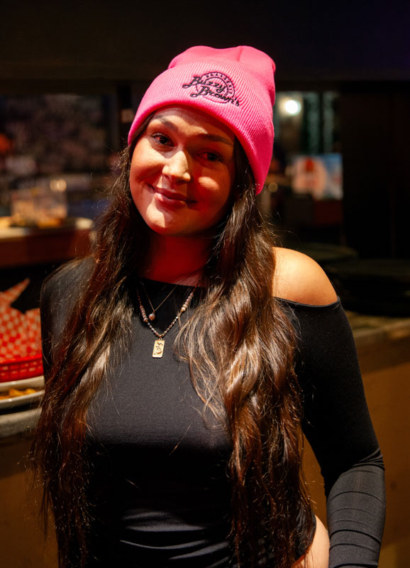A woman wearing a pink knit Buzzy Brown's toque.